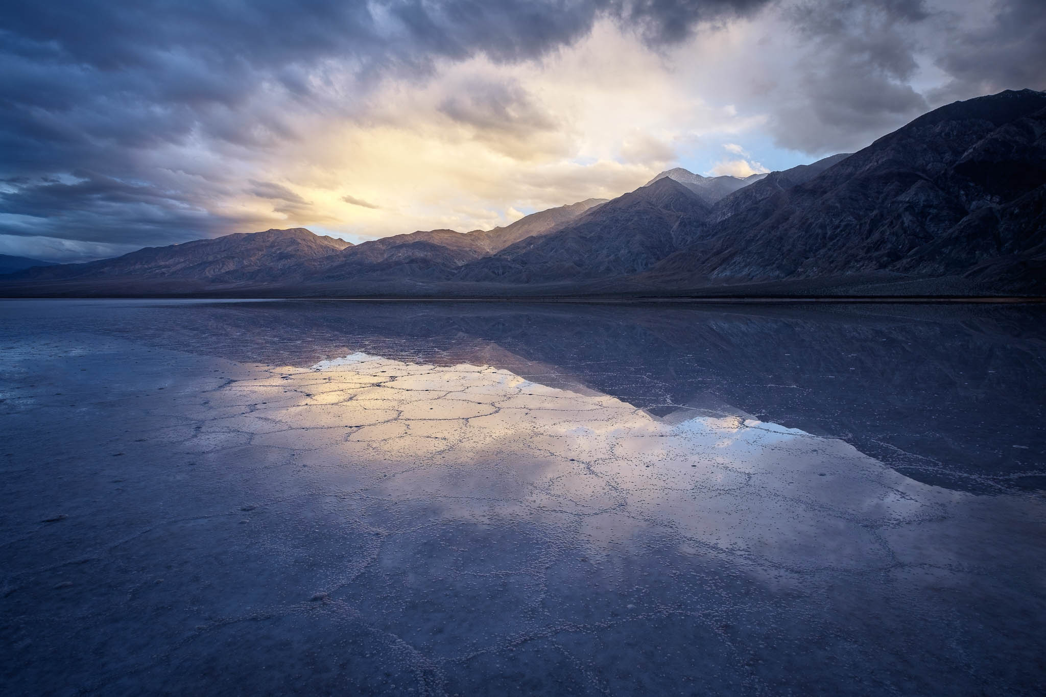 A spring fed salt flat glows under the setting sun in a remote area of Death Valley National Park